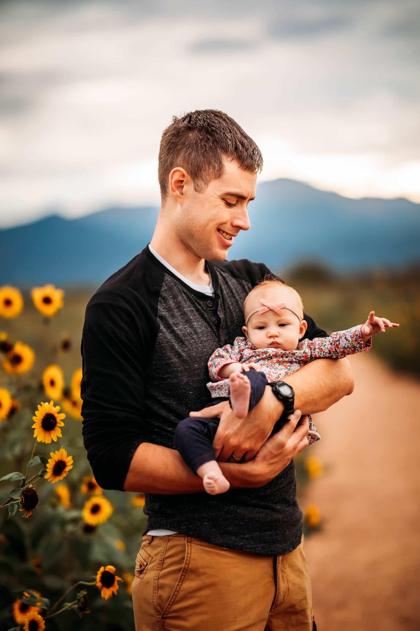 Dad and Daughter in sunflower field