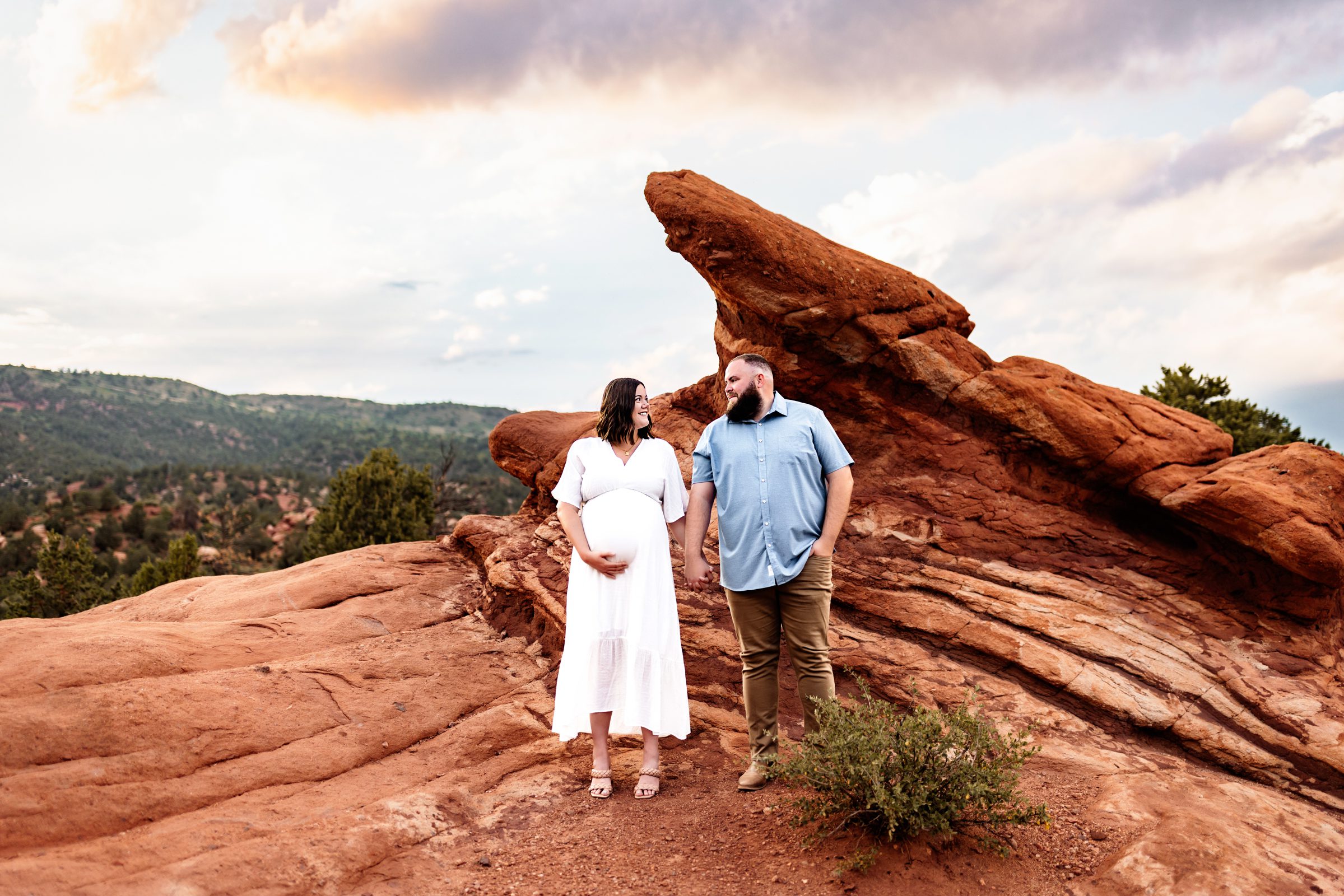 A couple at Garden of the Gods showcasing what to wear for maternity photos outdoors