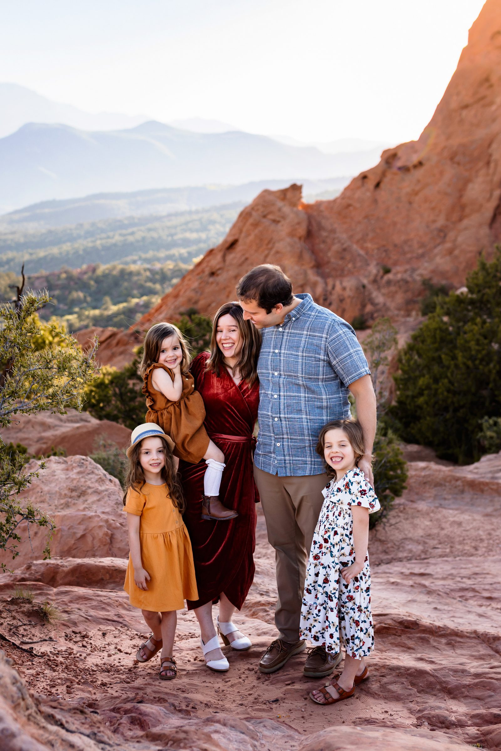 Colorado Springs travel photography session featuring a happy family at Garden of the Gods with mountain views.