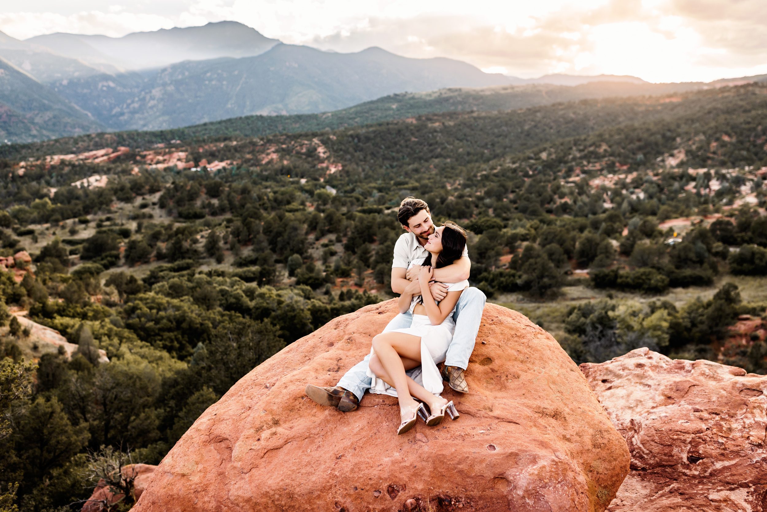 a couple in love sitting on a rock in colorado springs