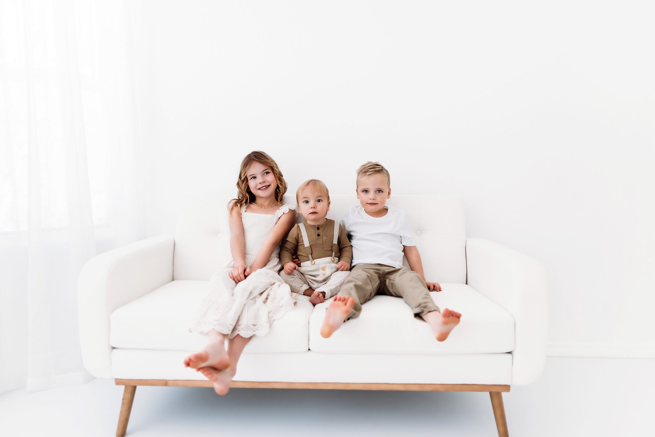 Sibling studio photos in Colorado Springs in a bright white studio space