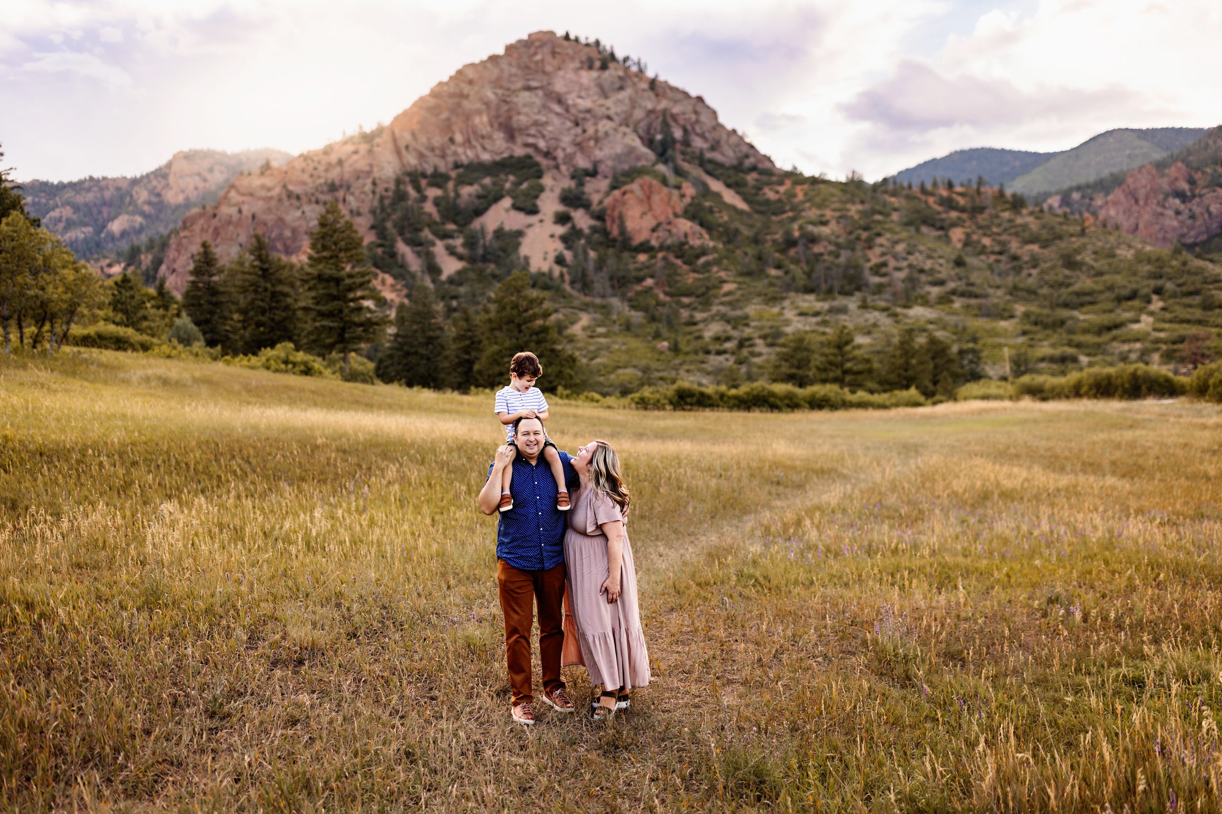 Family laughing together during Colorado Springs outdoor photography session at sunset