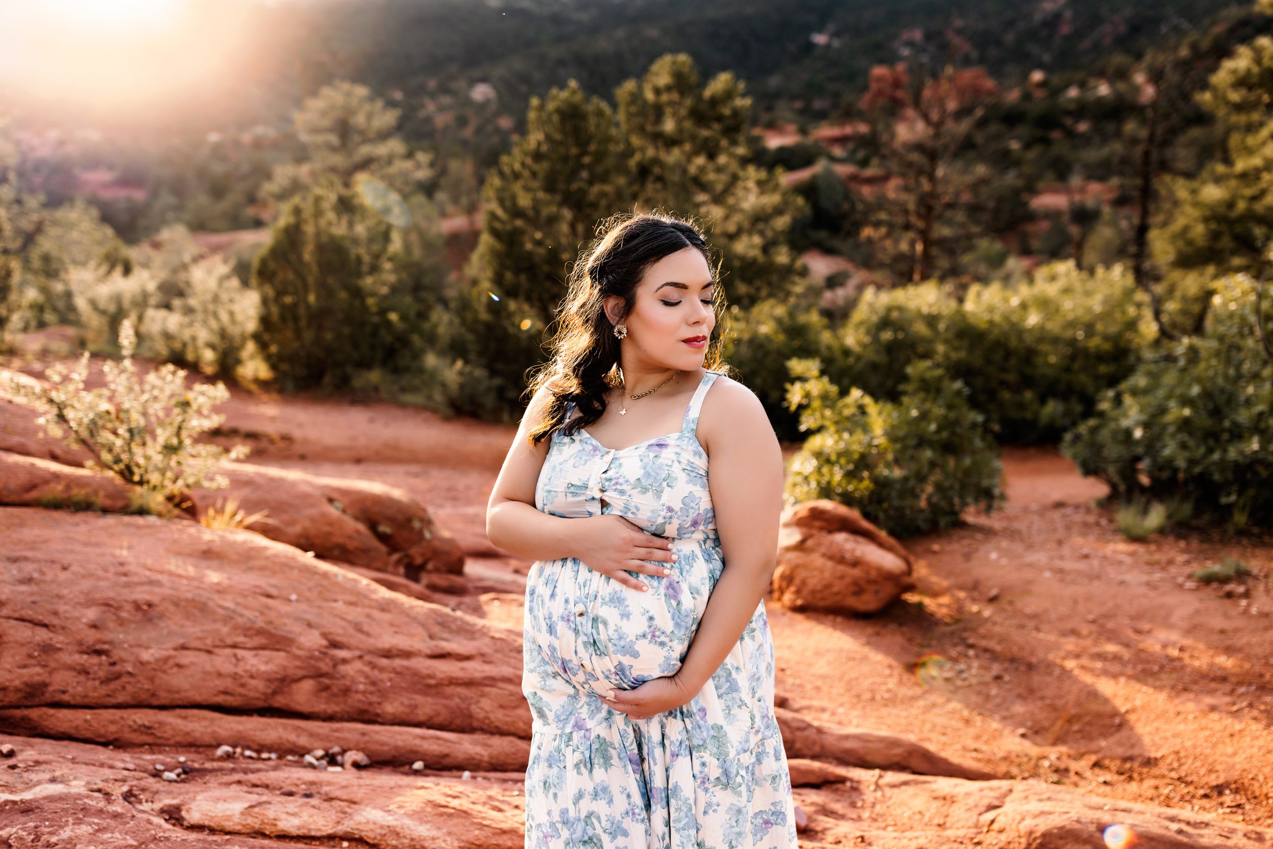 A pregnant mother hugging her baby bump
