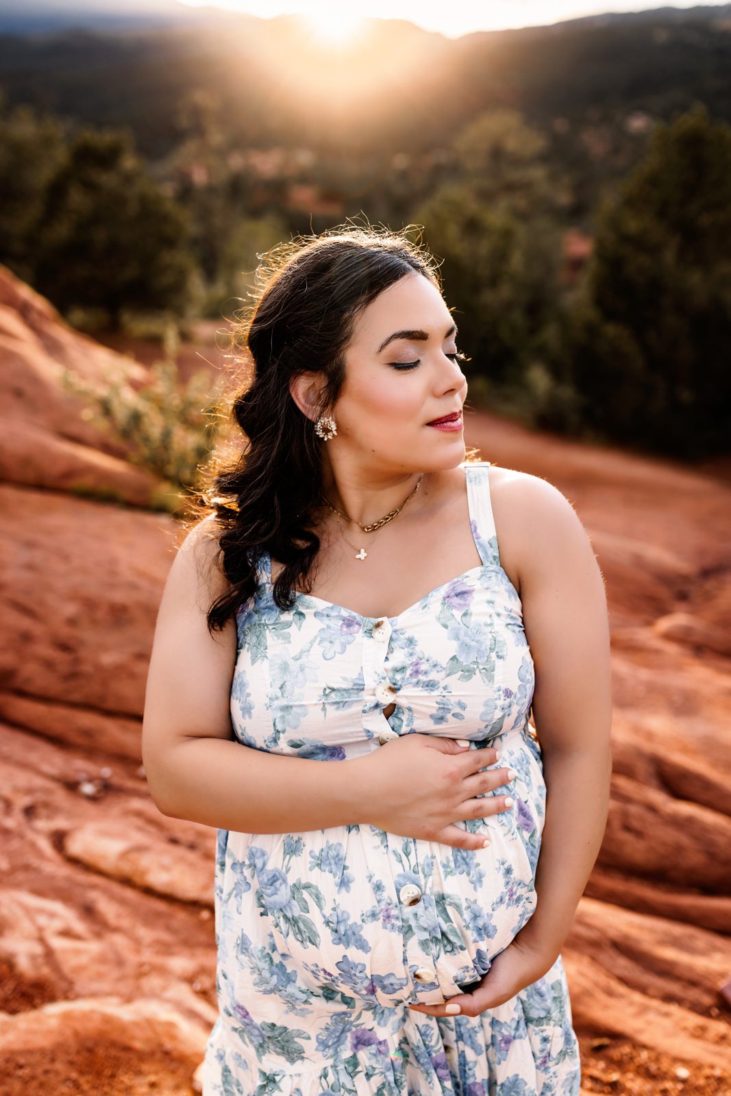 A pregnant mom with the setting sun behind at a colorado springs photo session