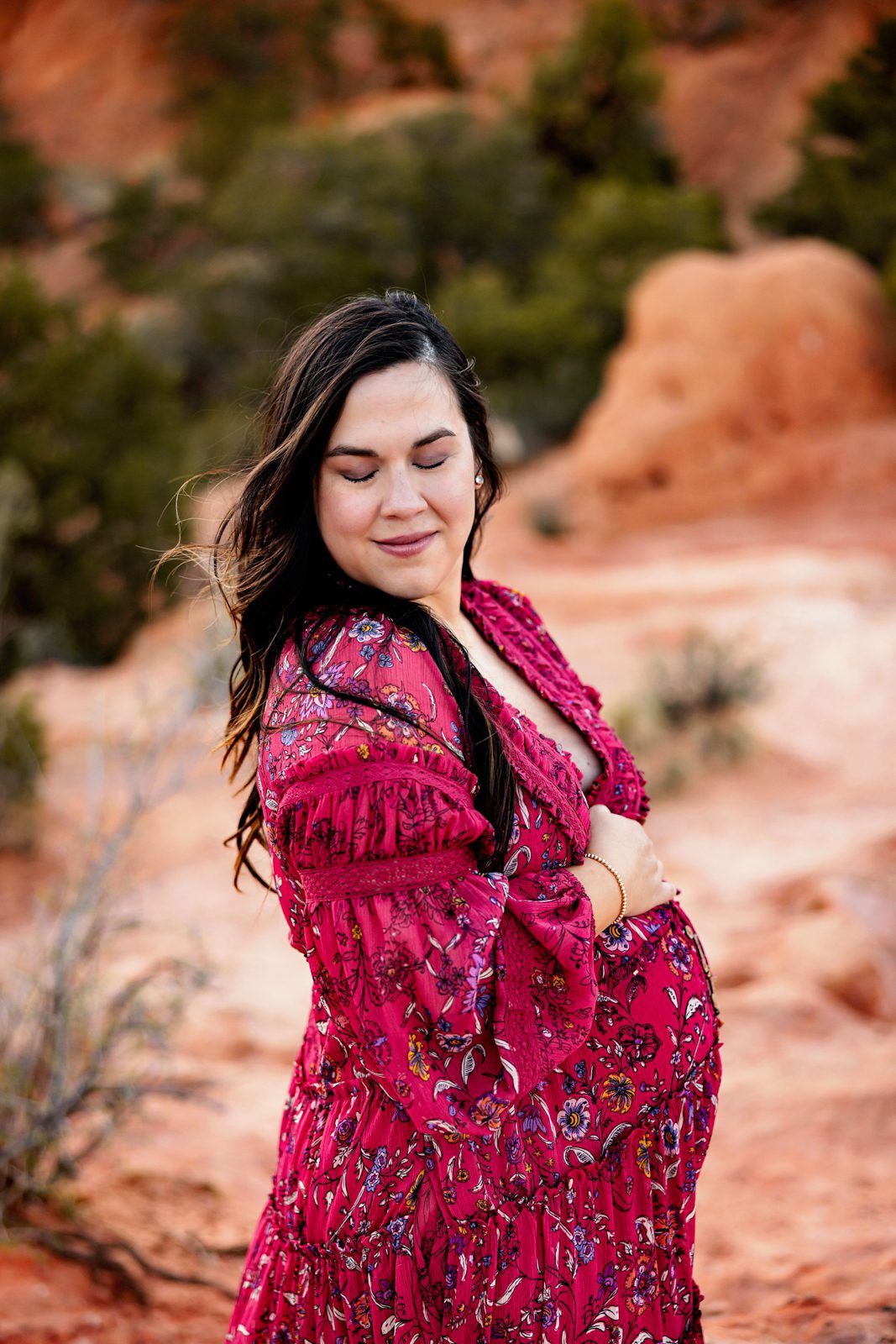 a pregnant ,mom in a beautiful red dress