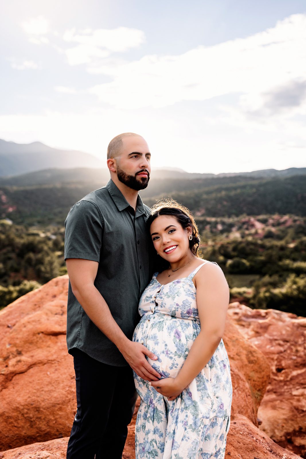 Close-up maternity photo with couple standing together on red rocks in Colorado Springs