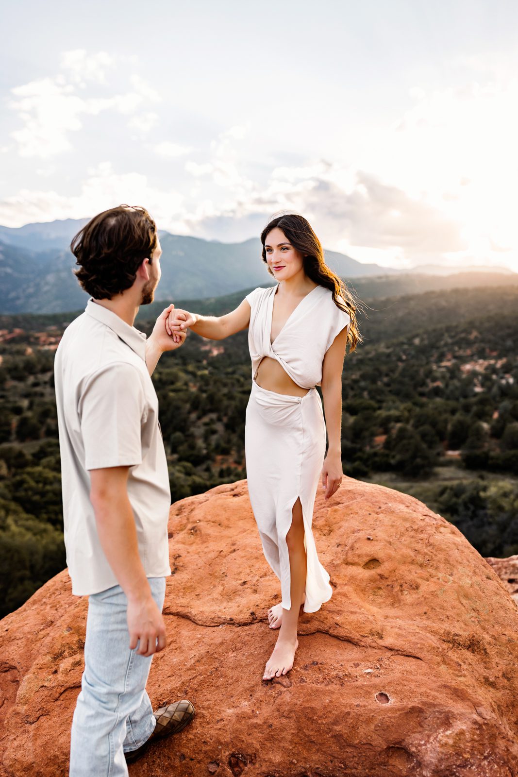 Adventurous couples session at Garden of the Gods with the couple exploring barefoot on the red rock formations.