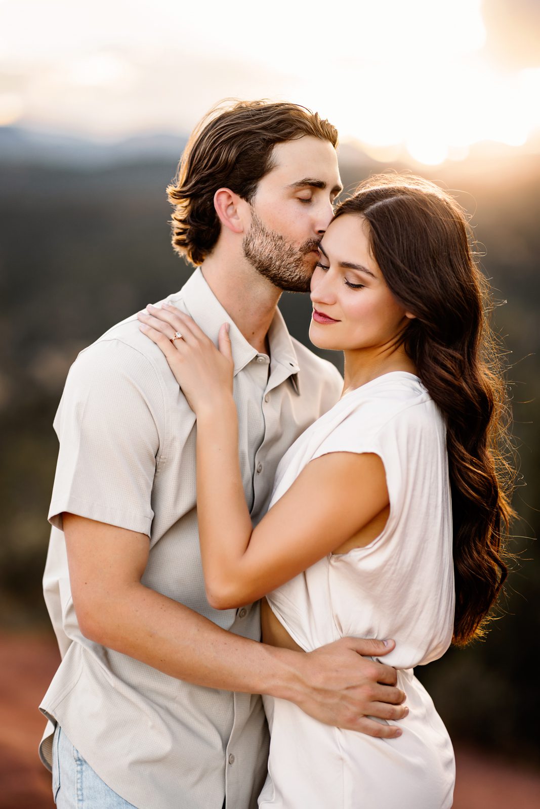 Intimate moment during a couples session at Garden of the Gods as the sun sets behind the mountains.