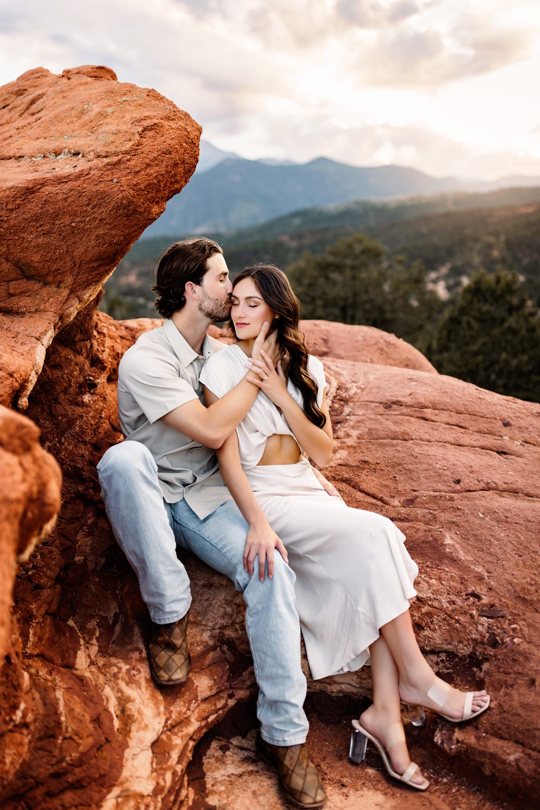 Sweet and cozy moment during a couples session at Garden of the Gods with unique rock formations.