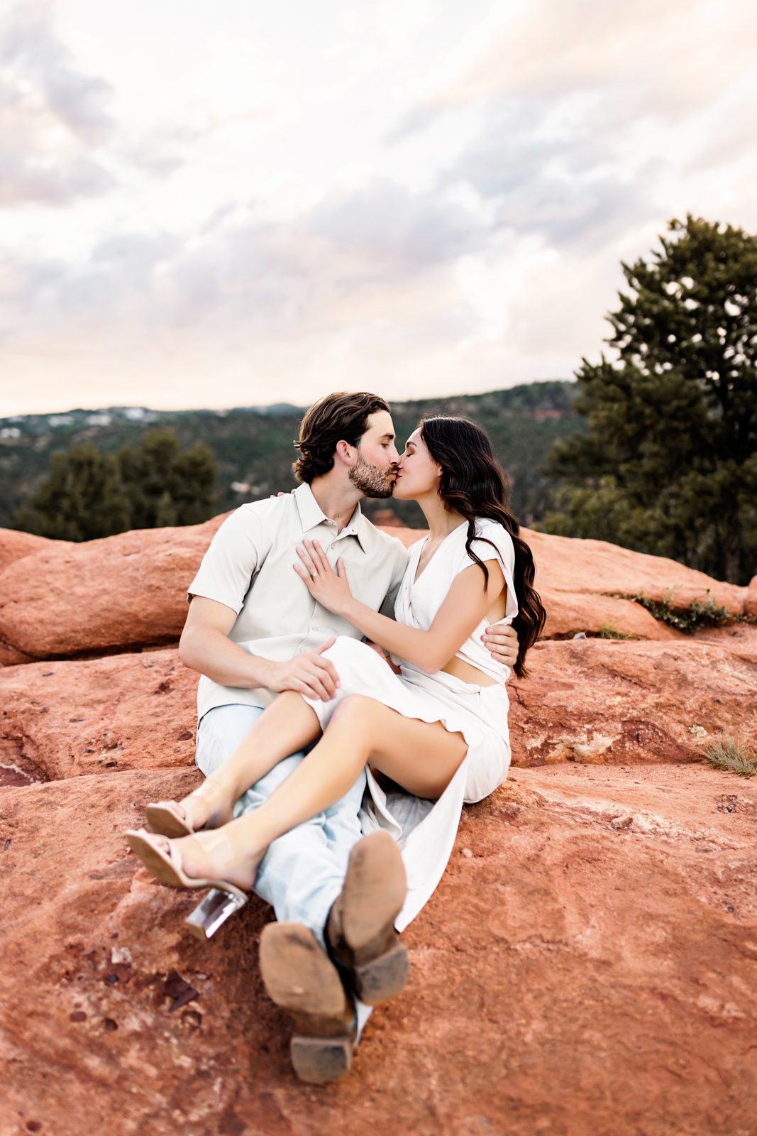 Sunset kiss captured during a couples session at Garden of the Gods with romantic, earthy tones.