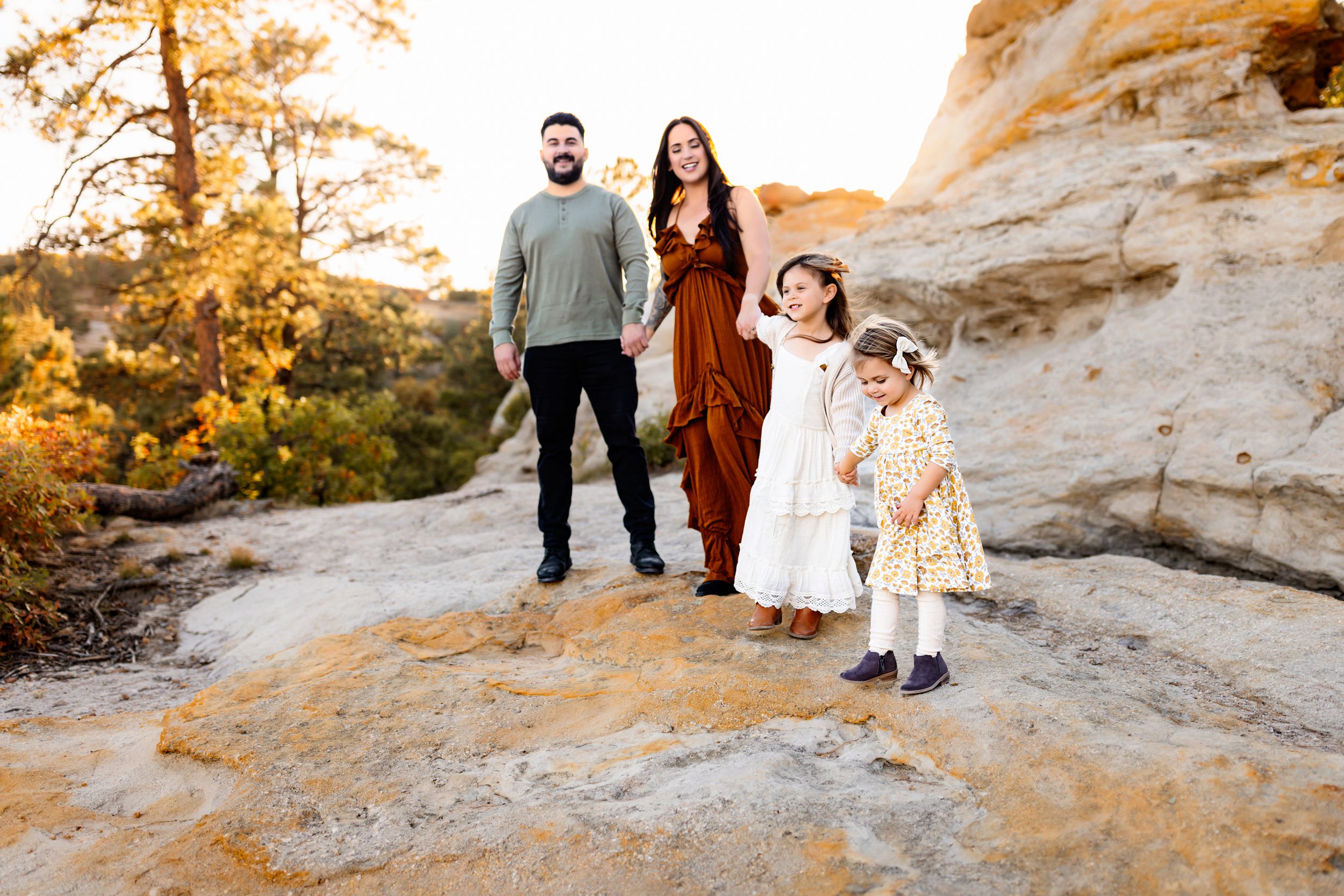 Adventurous family stroll captured in golden light with scenic views all around.