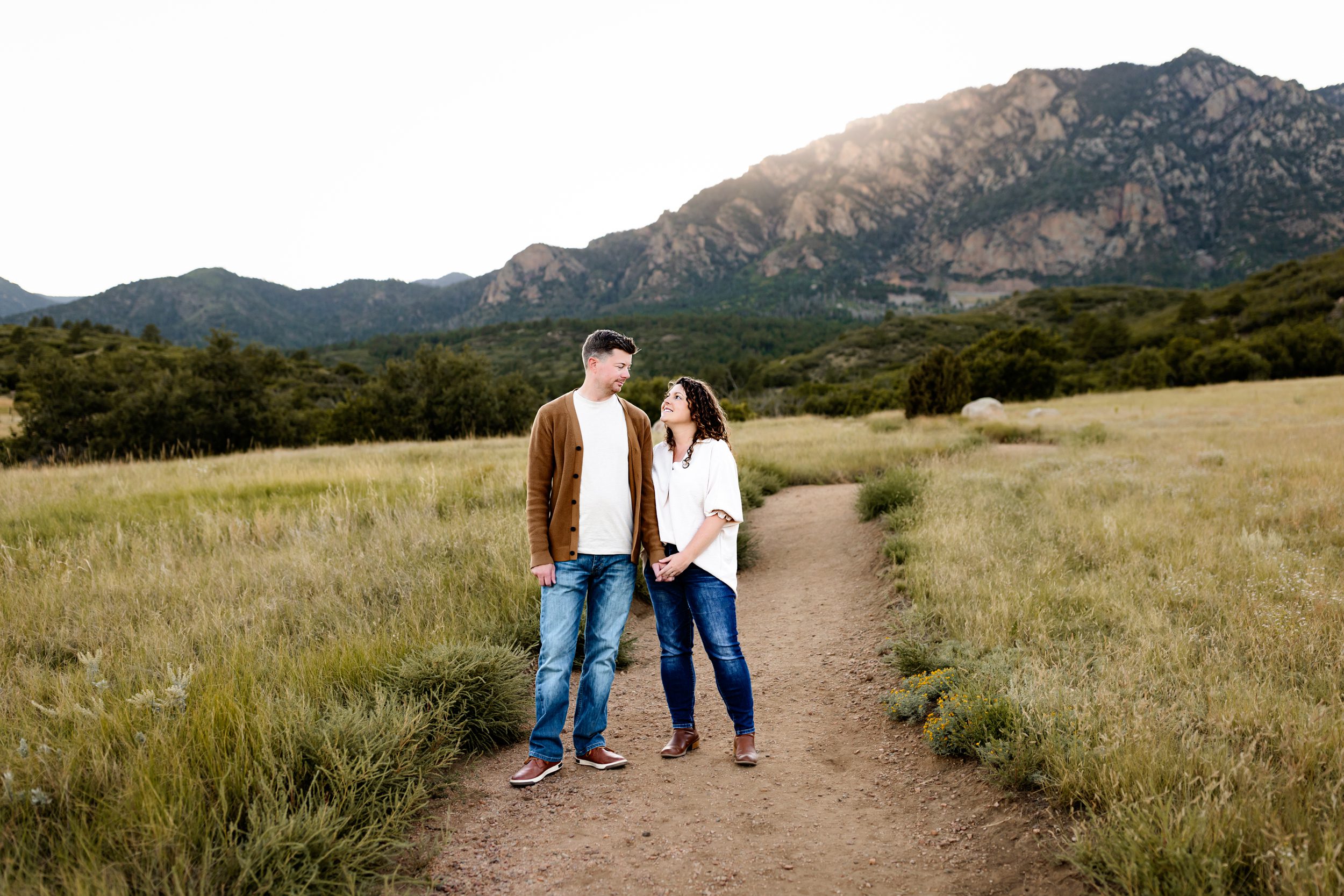 Couple standing on a trail during a golden hour family photo session in the Colorado mountains.