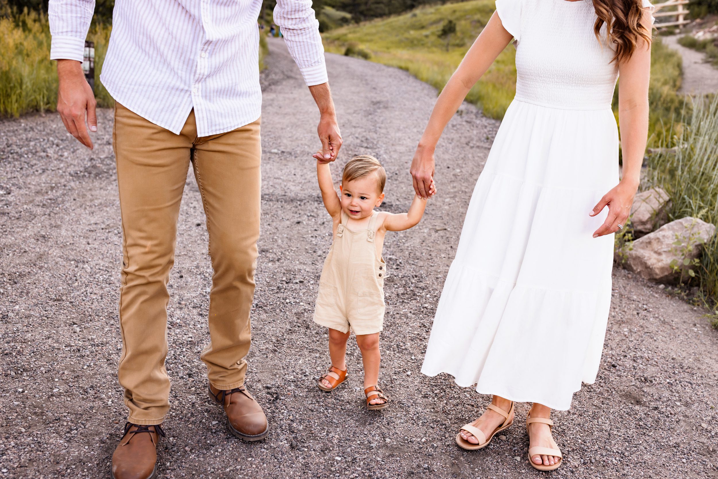 Summer Outfits for Babies and Toddlers with neutral tones featuring a baby in a tan romper and sandals