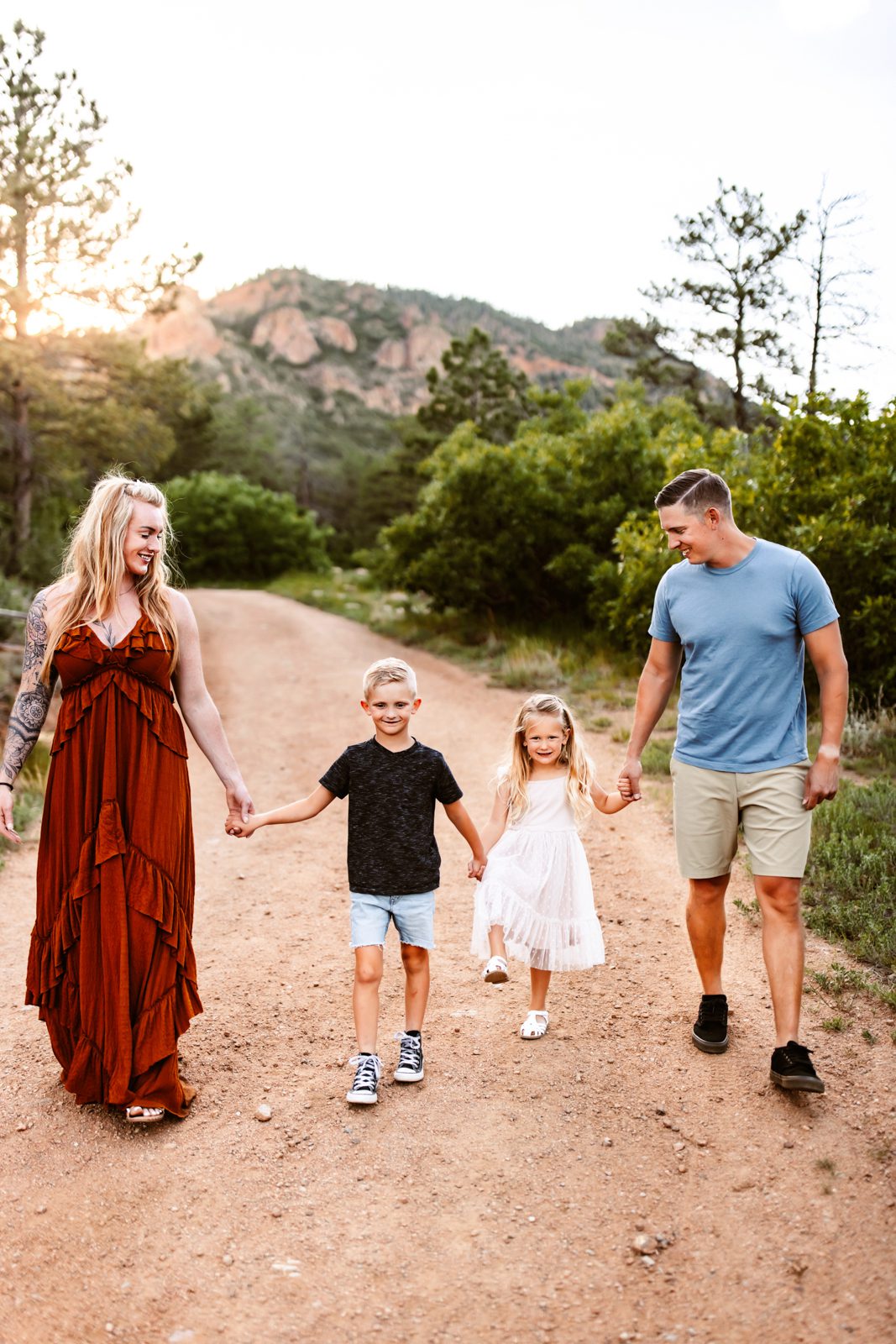 Family walks away together, enjoying a peaceful candid family photography moment at sunset