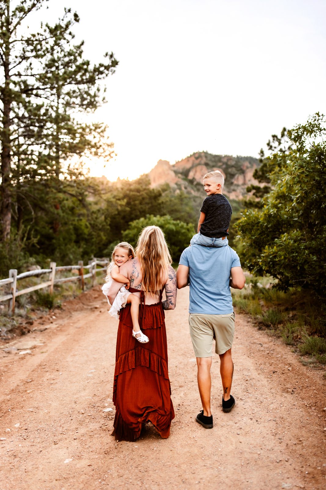 Family captured from behind in candid family photography, enjoying a peaceful walk together with kids smiling warmly