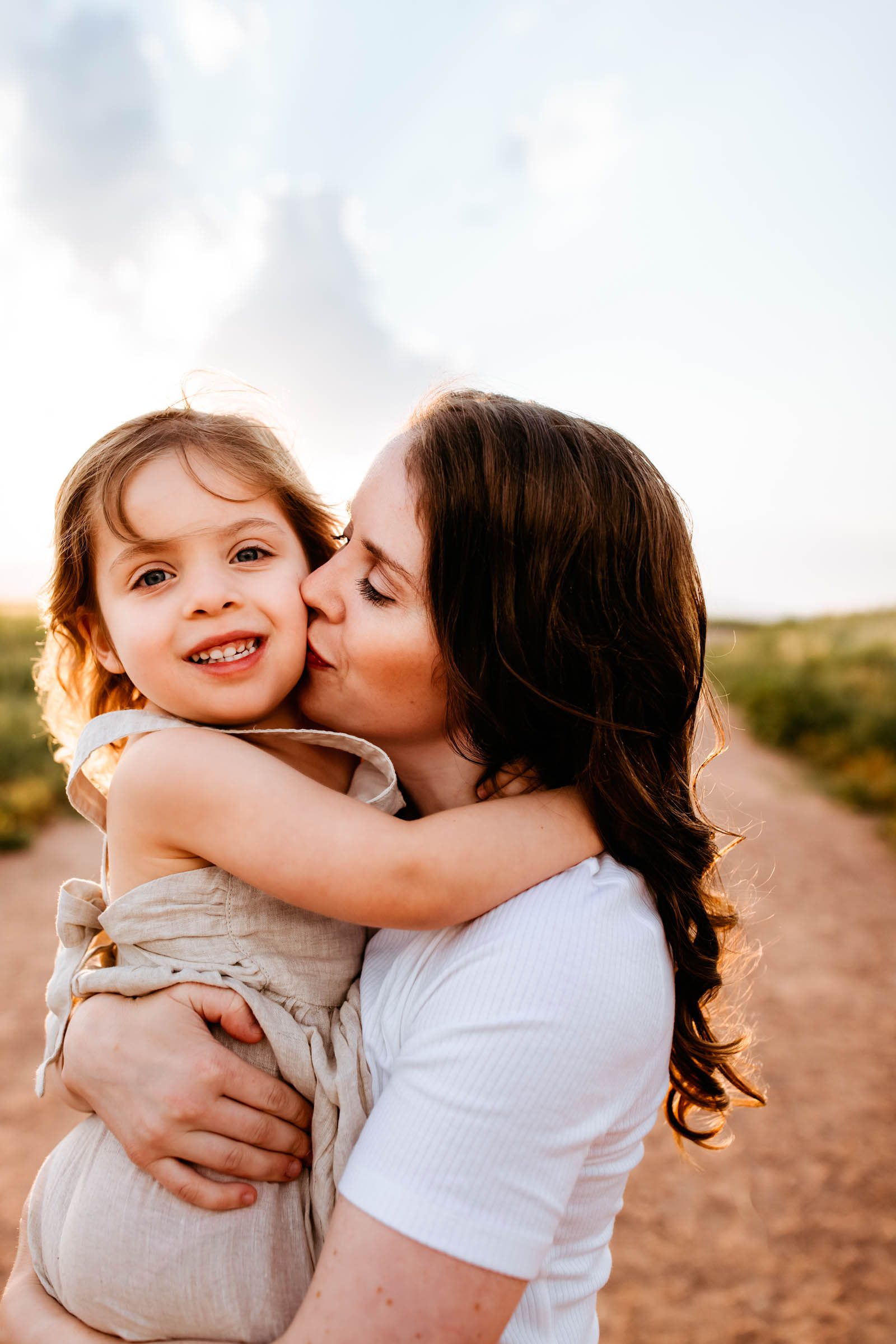 A tender moment captured between a mother and daughter, sharing a sweet kiss during their Colorado Springs Summer Session.