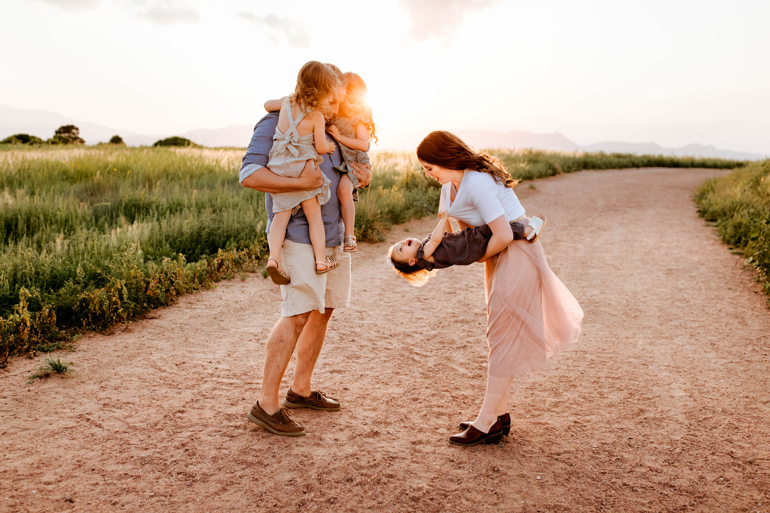 Adorable upside-down giggles from a toddler being playfully held by mom during their Colorado Springs Summer Session.