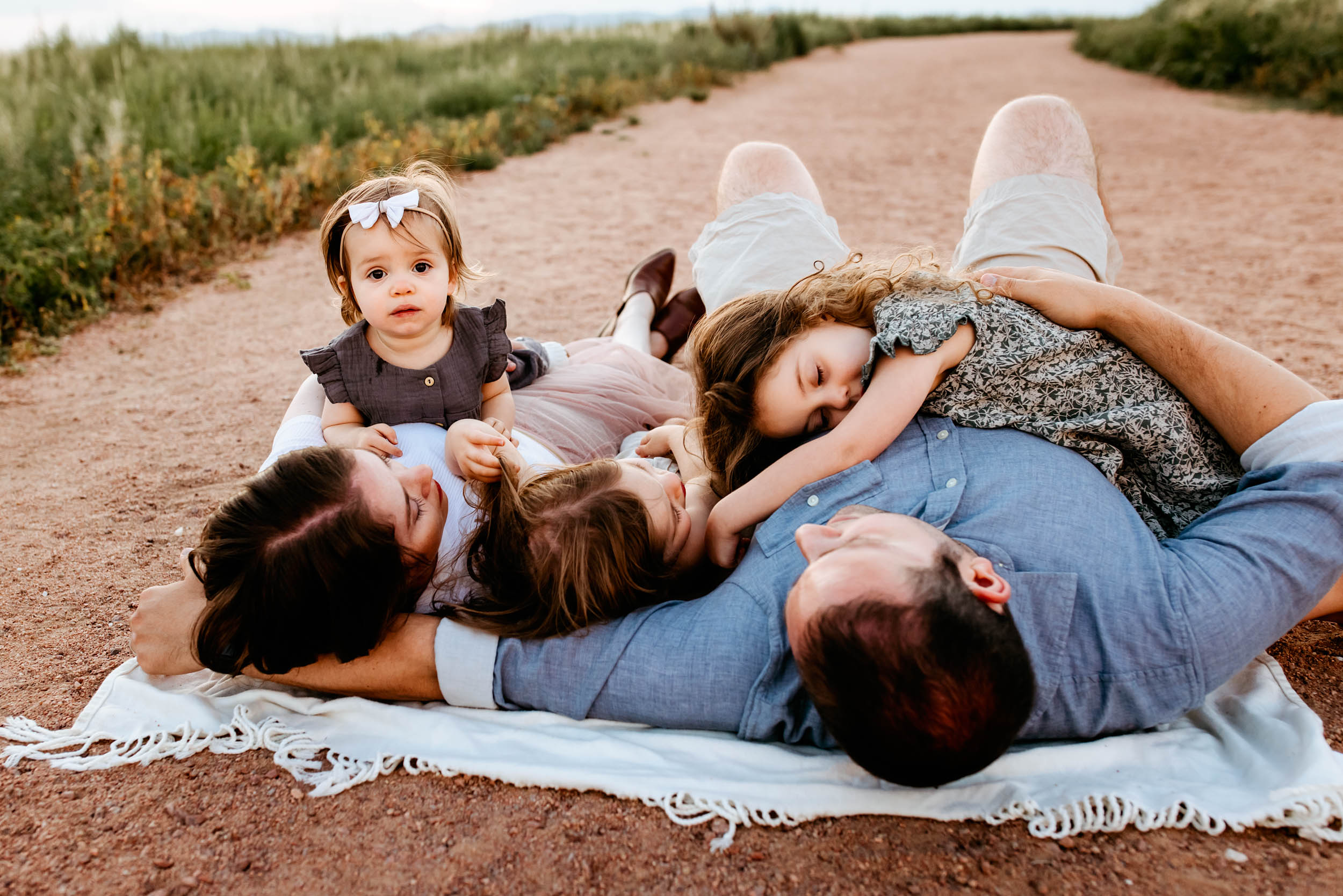 Overhead view of a family comfortably snuggled together, sharing joyful laughter.