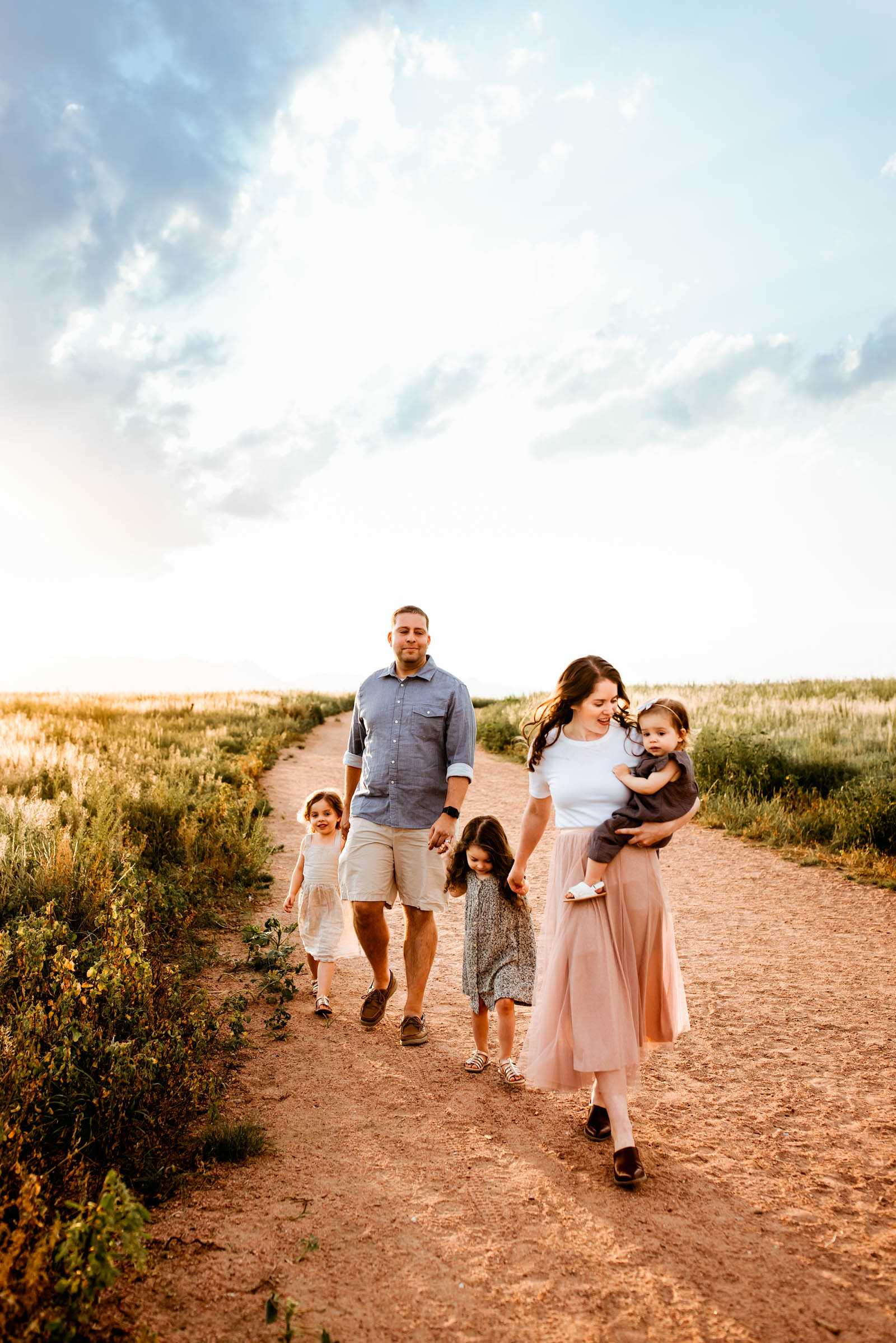 Family enjoying a calm, scenic walk together, creating joyful memories at sunset.