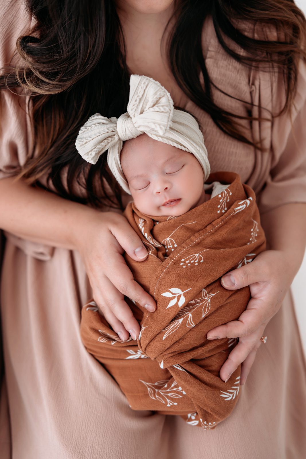 Newborn baby in her moms arms