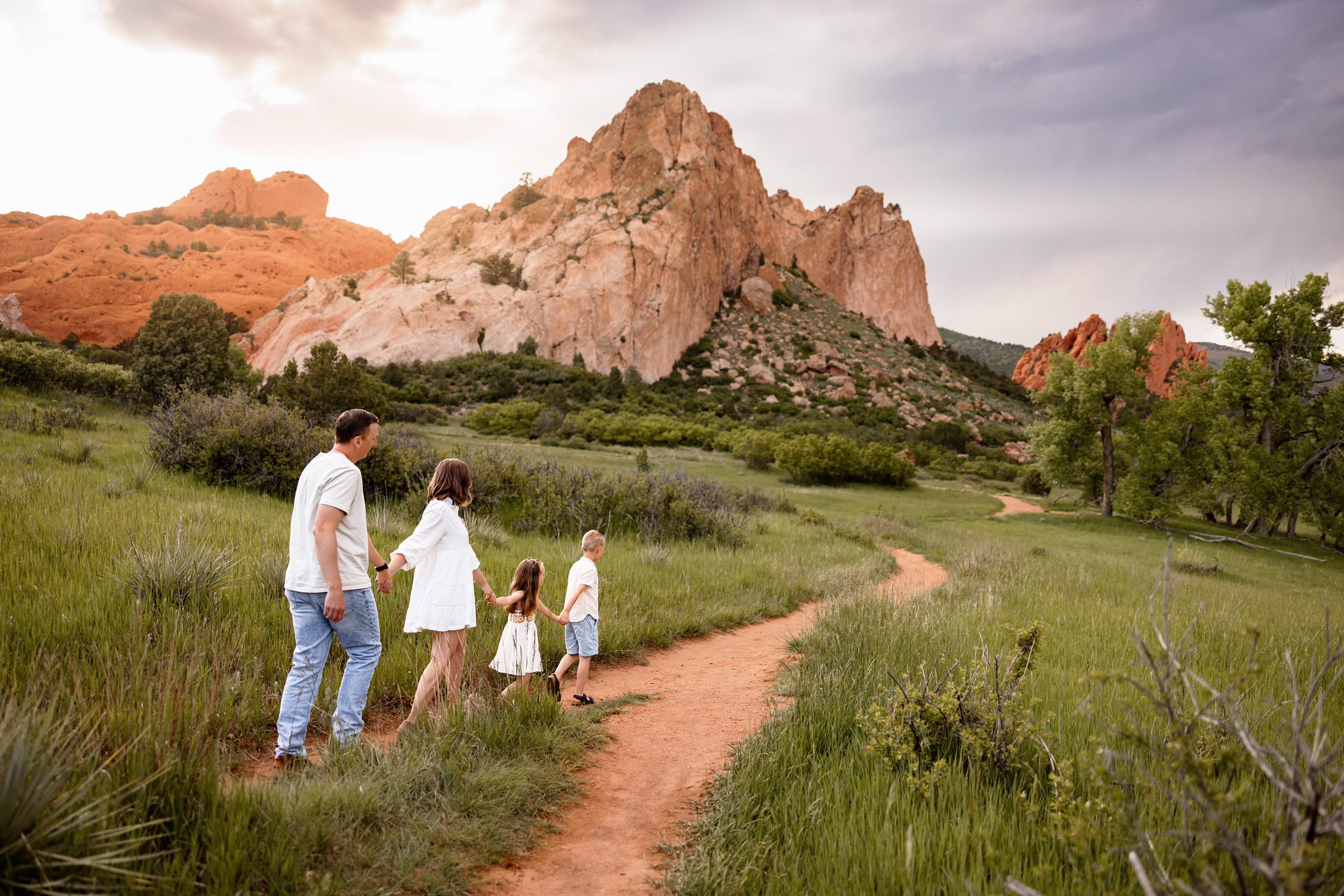 Summer photo locations in Colorado Springs with a family walking along a trail at Garden of the Gods