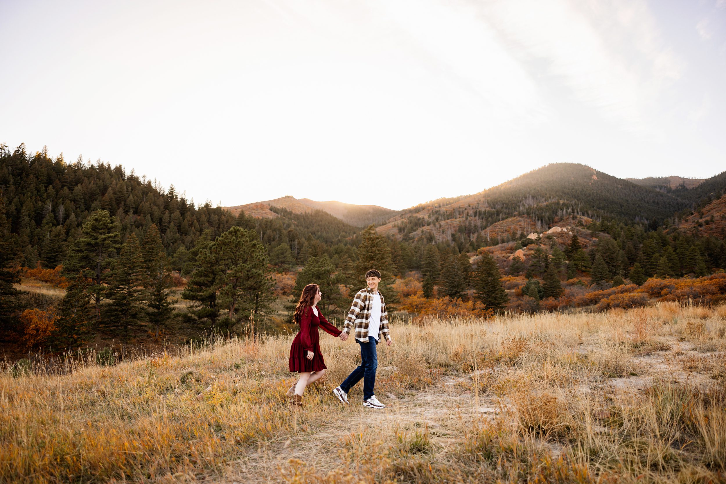 Couple exploring a mountain trail with wide scenic views and fall colors in Colorado Springs