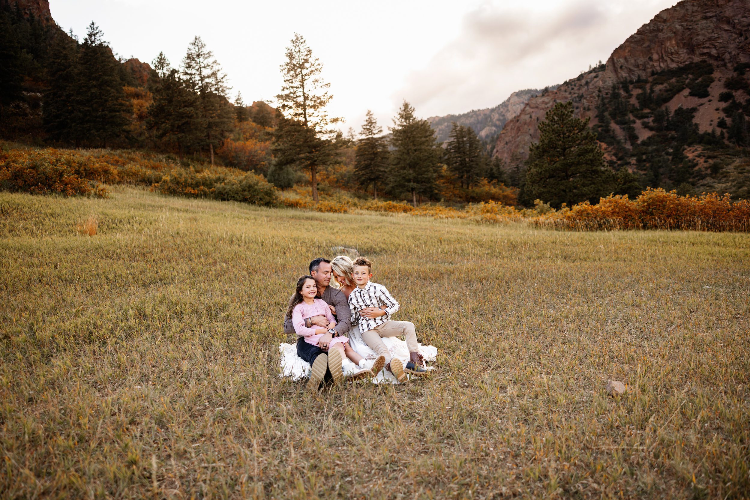 North Cheyenne Canon Family Photos of family cuddling together on a blanket in an open field
