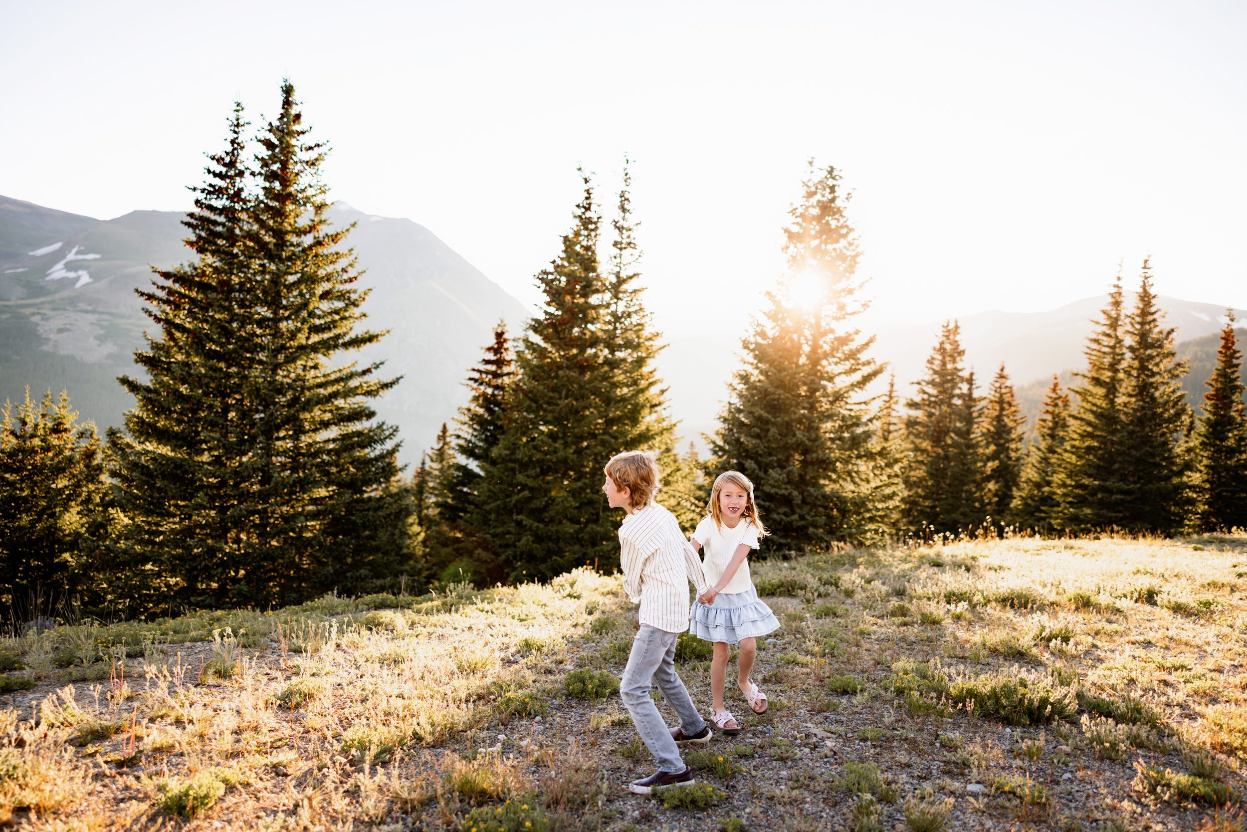 Kids spinning and playing together in golden hour light at Hoosier Pass in Breckenridge