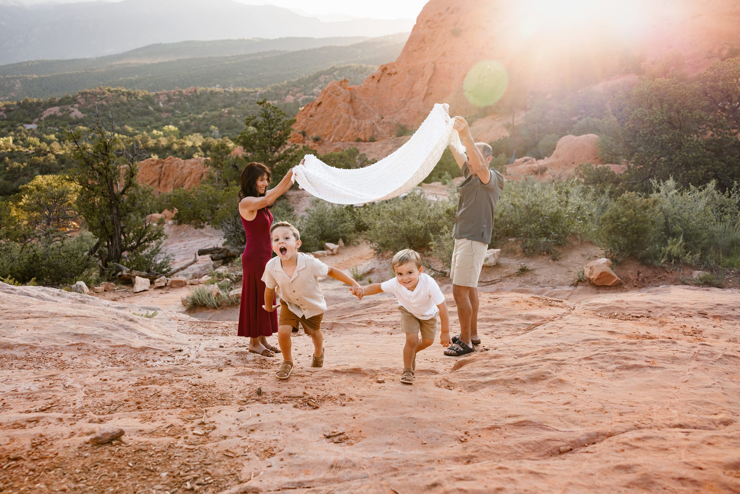 Kids running while grandparents hold a blanket behind them, including grandparents in your family photos