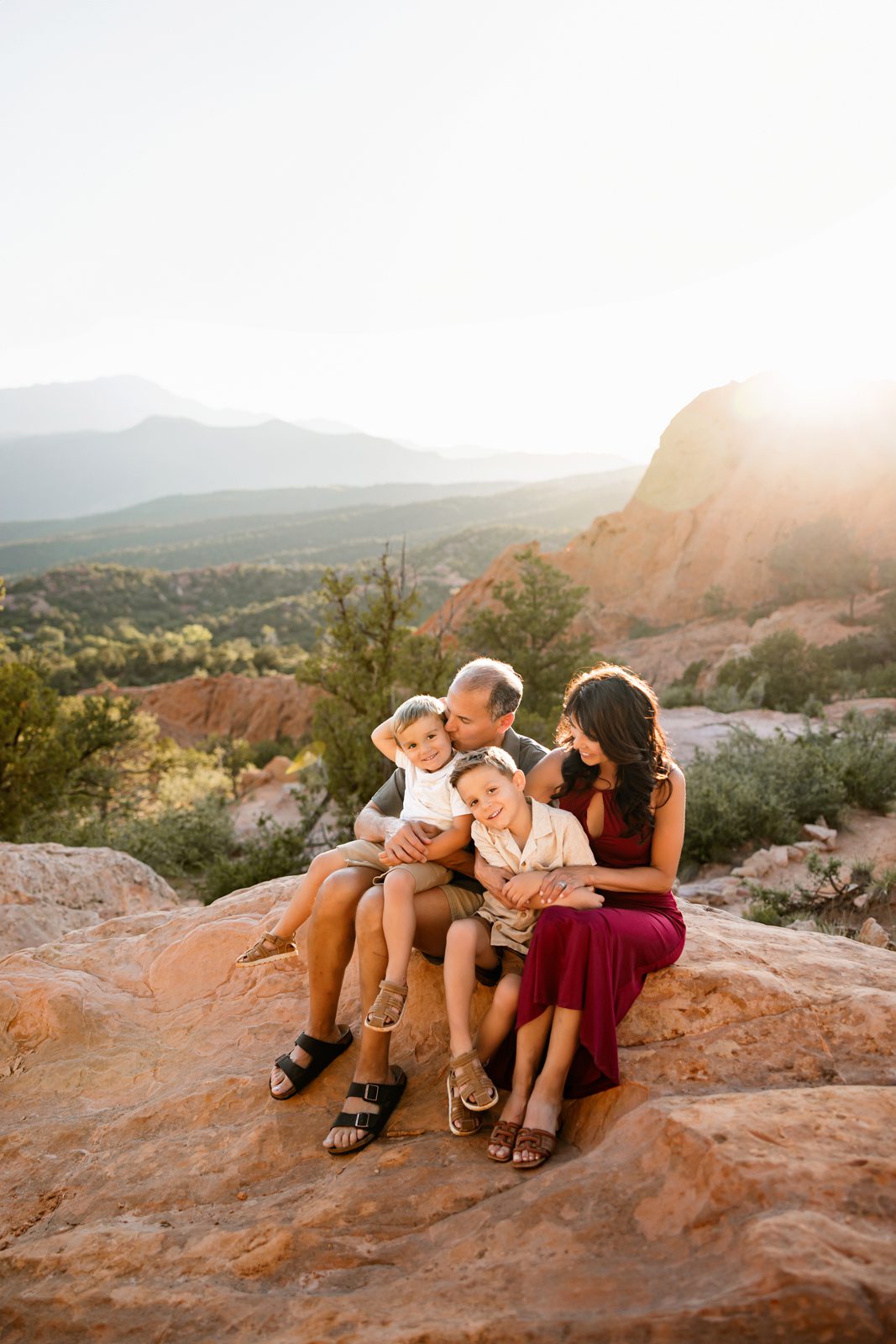 Grandparents holding grandchildren on a scenic overlook, including grandparents in your family photos