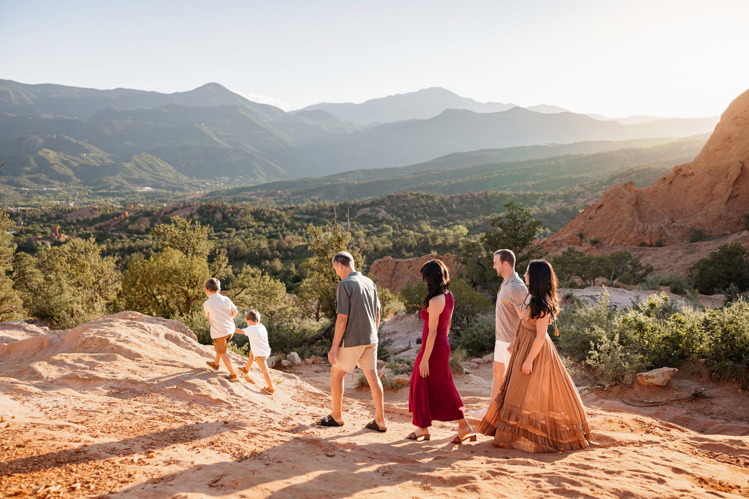 Family walking together through red rocks at Garden of the Gods, including grandparents in your family photos