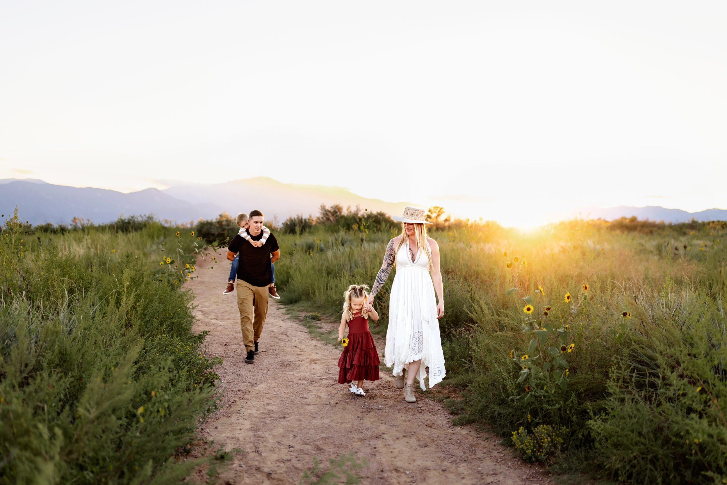 Summer photo locations in Colorado Springs with a family walking a trail during golden hour light