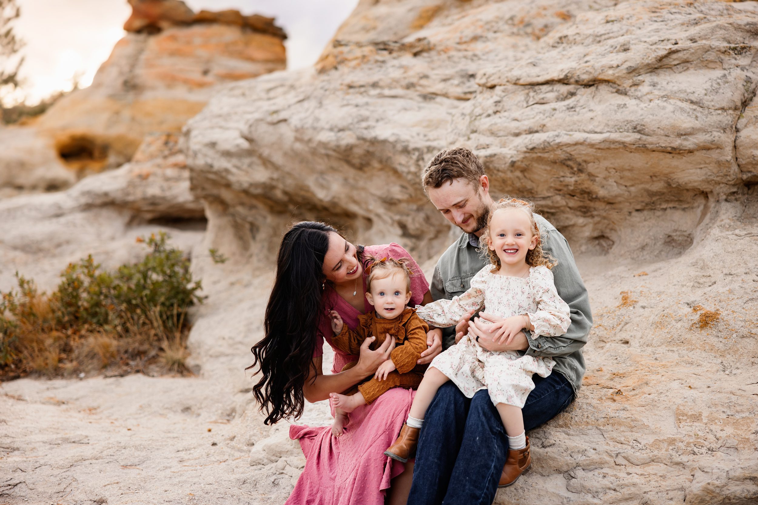 a close up of parents looking at their smiling daughters during their colorado springs mini session