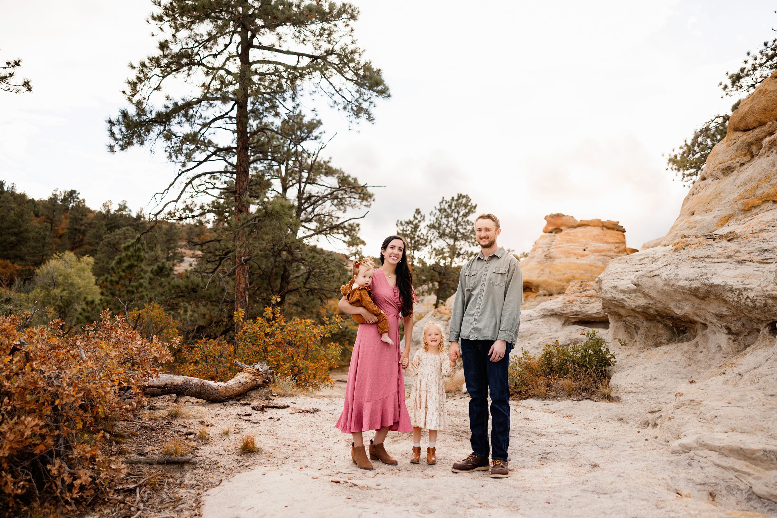 Mini session tips showing a family walking together through a rocky path with warm fall tones and natural movement